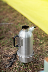 Stainless steel kettle is placed on the stove to boil water for cooking and coffee. Morning, camping, outdoor activities with family. And companions on vacation