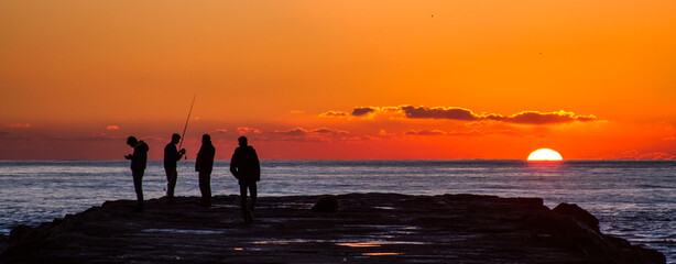 Four fishermen at Caparica´s sunset