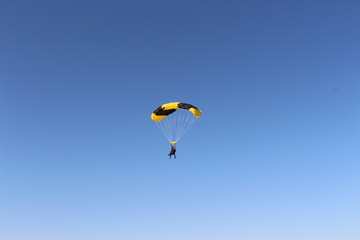 Person falling from the sky by parachute