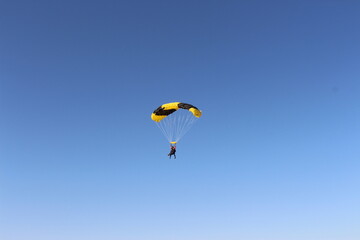 Person falling from the sky by parachute