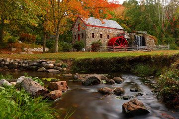 The Wayside Inn Grist Mill with water wheel and cascade water fall in Autumn. 