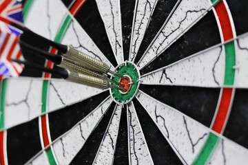 red three darts arrows in the target center business goal concept.
Dart arrow in the target center.Many attempts to hit the target.