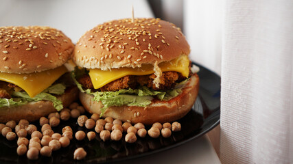 Vegetable Burger with chickpea cutlet. Two burgers on a black plate
