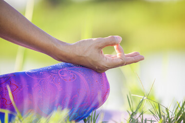 Portrait of gorgeous young woman practicing yoga with nature background.