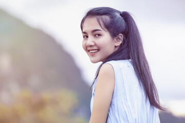Fototapeta premium Cheerful young woman taking a selfie with nature.