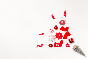 Fototapeta na wymiar Christmas gift. Stocking, gifts, winter tree, ribbon and bow in Christmas composition on white background for greeting card. Copy space. Winter holidays, New Year.