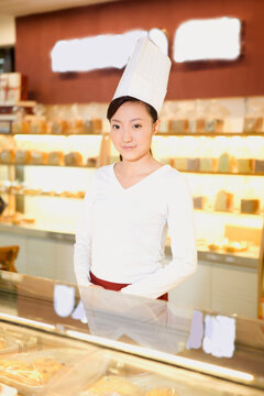 The happy bakery saleswoman is in the bakery 