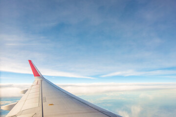 Sky and cloud as seen through airplane window on the wing