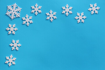 Creative Christmas or New Year composition. View from above. The background is blue with wooden toys and copy space. Greeting card mockup. Flat lay.