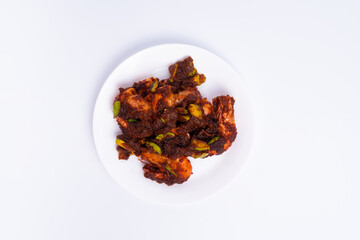 The top angle of Sambal petai udang (shrimp petai sauce) is a typical asian cuisine food. food made from shrimp, petai, and chili sauce. Isolated on white background