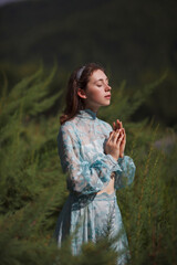 Girl in a blue dress in the forest