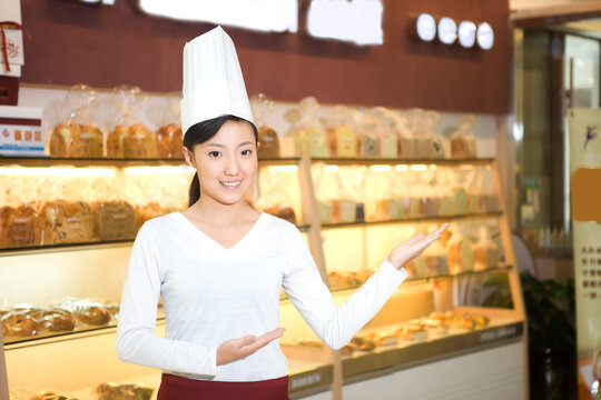 The happy bakery saleswoman is in the bakery 