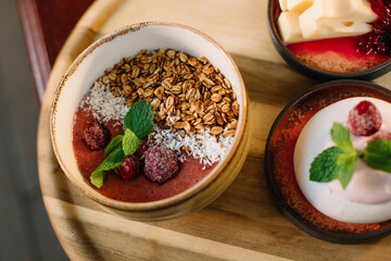 Healthy breakfast of cereals and strawberries on a tray
