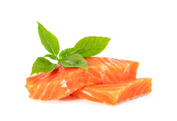 Piece of fresh salmon fillet sliced with leaf basil isolated on white background