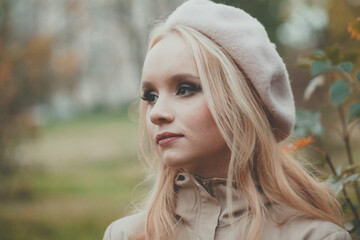 Portrait of beautiful autumn woman in beret outdoors
