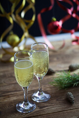 Christmas background, champagne glasses on a wooden surface