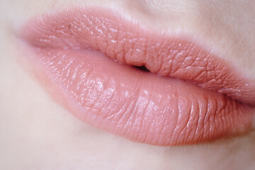 Obraz premium Pink lips and red fingernails, closeup. beauty lips background. lips of a young woman close up. red lips and nail.