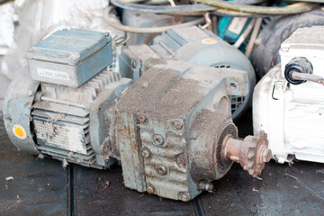 Old motor laid on the floor. The old motor is scrapped. Rusty old motor