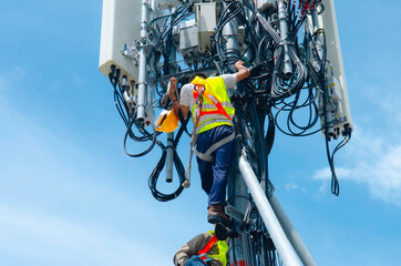 technician working on high telecommunication tower,worker wear Personal Protection Equipment for working high risk work,inspect and maintenance equipment on high tower.