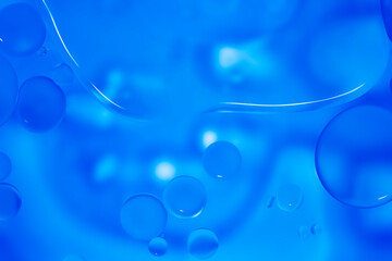 Blue glitter vintage lights background. Blue texture background. Oil drops in water.