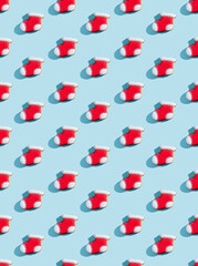 Christmas cookies decor. Festive bakery pattern. New Year symbol. Traditional winter sweets. Gingerbread biscuit figure stocking socks red white icing isolated on blue pastel.