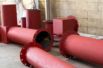 Rust-proof painted steel pipes in the factory. Red iron pipe