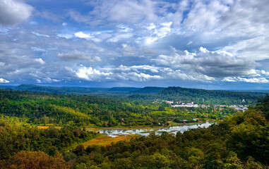 Fototapeta na wymiar Peaceful forest and mountains over Chong Mek checkpoint terminal, the land bridge permanent border pass to Laos. View from Wat Phu Prao, Ubon Ratchathani, Thailand