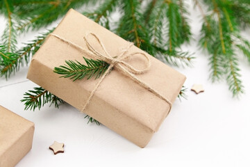 Christmas gift box and fir tree branches on white background.