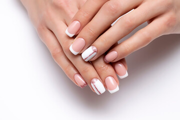 French wedding white manicure with pink glittery stripe and shiny little finger on long square nails close-up on white background