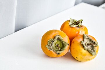 Ripe persimmon on a white background. Top view.
