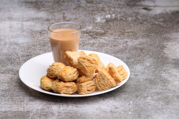 indian khari or kharee or salty Puff Pastry Snacks, served with indian hot tea.