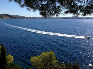 mediterranean coast with blue ocean and boat  - 387424322