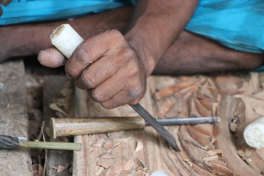 Close up of carving gouge chisel  designing a wooden plank at a workshop. Carpenter tool concept