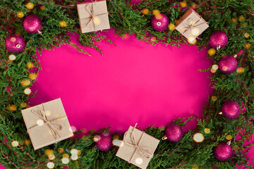 Fototapeta na wymiar Flat lay new year cristmas boxes, balls and pine tree on pink paper background. High quality photo