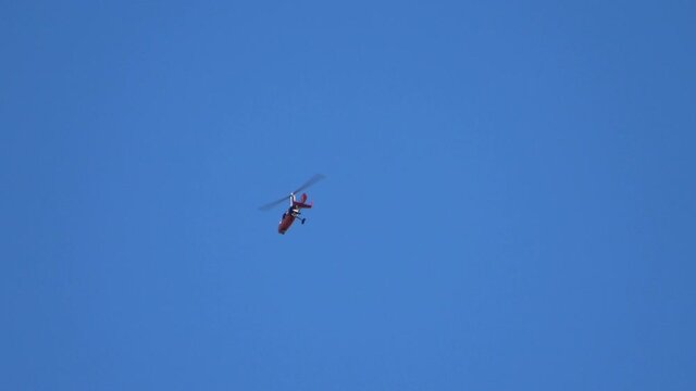 Helicopter flying in a deep blue sky