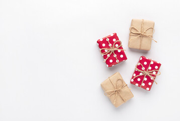 Christmas gifts composition. New year flatly with red dotted and craft gifts at gray background. Hygge concept.