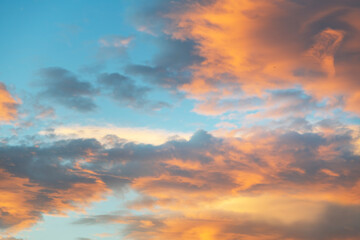 Naklejka na ściany i meble Beautiful colorful bright sunset sky with orange clouds. Nature sky background.