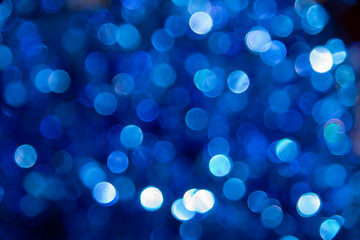Naklejka na ściany i meble Abstract holiday blurry background of glowing blue lights