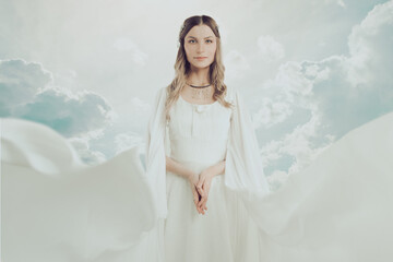 Fototapeta na wymiar Mysterious woman in white dress on sky clouds background