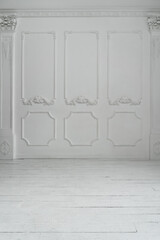 Empty white room with stucco decor on wall and wooden flor. Abstract background.