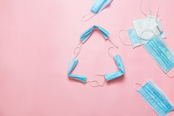 Recycle sign made from used medical mask. Throws a medical mask into the recycling box concept. Blue face masks after use. Medical masks utilizing