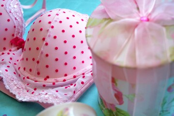 Pink bra with red polka dots and a pink flower print gift box