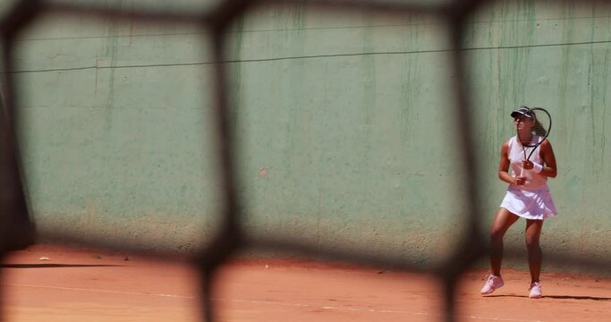 Woman Playing Tennis Pov Through Court Net