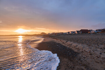 Sunrise on the beach in Denmark. Fishermen and tourist houses. Klitmoller.