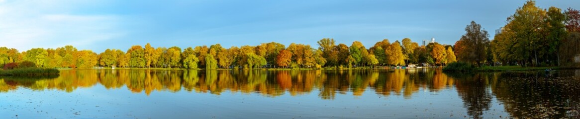 Beautiful large panorama of lake with colorful trees in Autumn season 