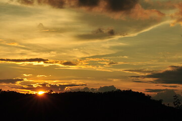 Sunset view with beautiful golden sky,the colorful sky lights in the evening