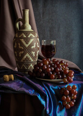 still life with wine and red grapes