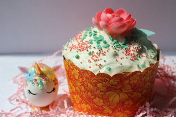 Easter composition with easter egg unicorn and easter cake, kulich with flower on white background