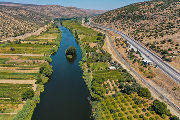 River separates the fields . Tuna river is one of the biggest river in the world