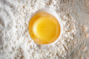 chicken yolk on flour close-up